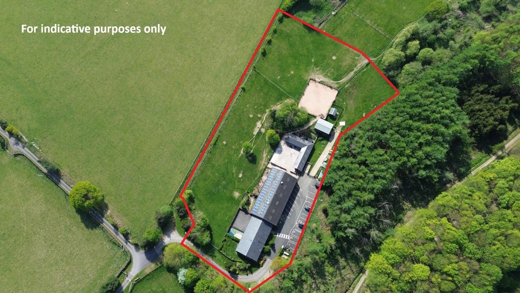 Aerial photo of a building among green fields with text 'For indicative purposes only'